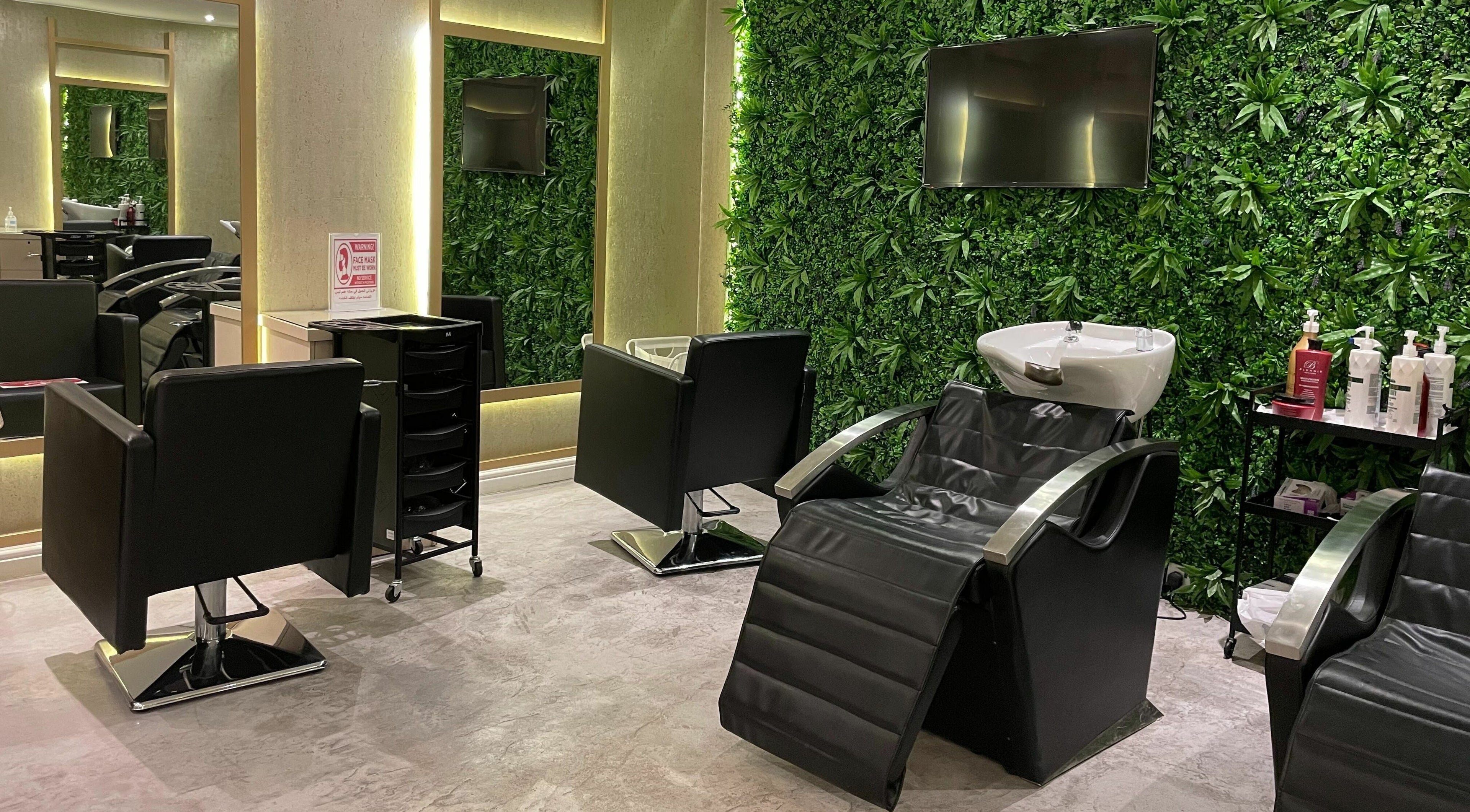 Luxurious salon chairs at Zoz Lashes - Riyadh, Riyadh Province, SA, featuring lush greenery walls.