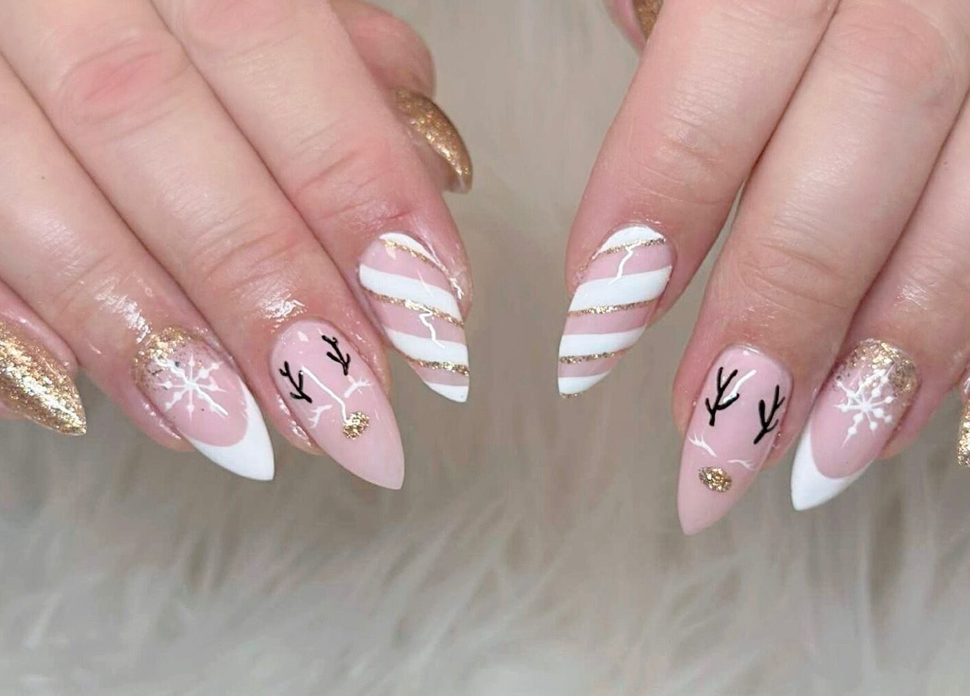 Festive nail art with gold glitter and white patterns at Beauticure Nails, Toronto, Ontario, CA.