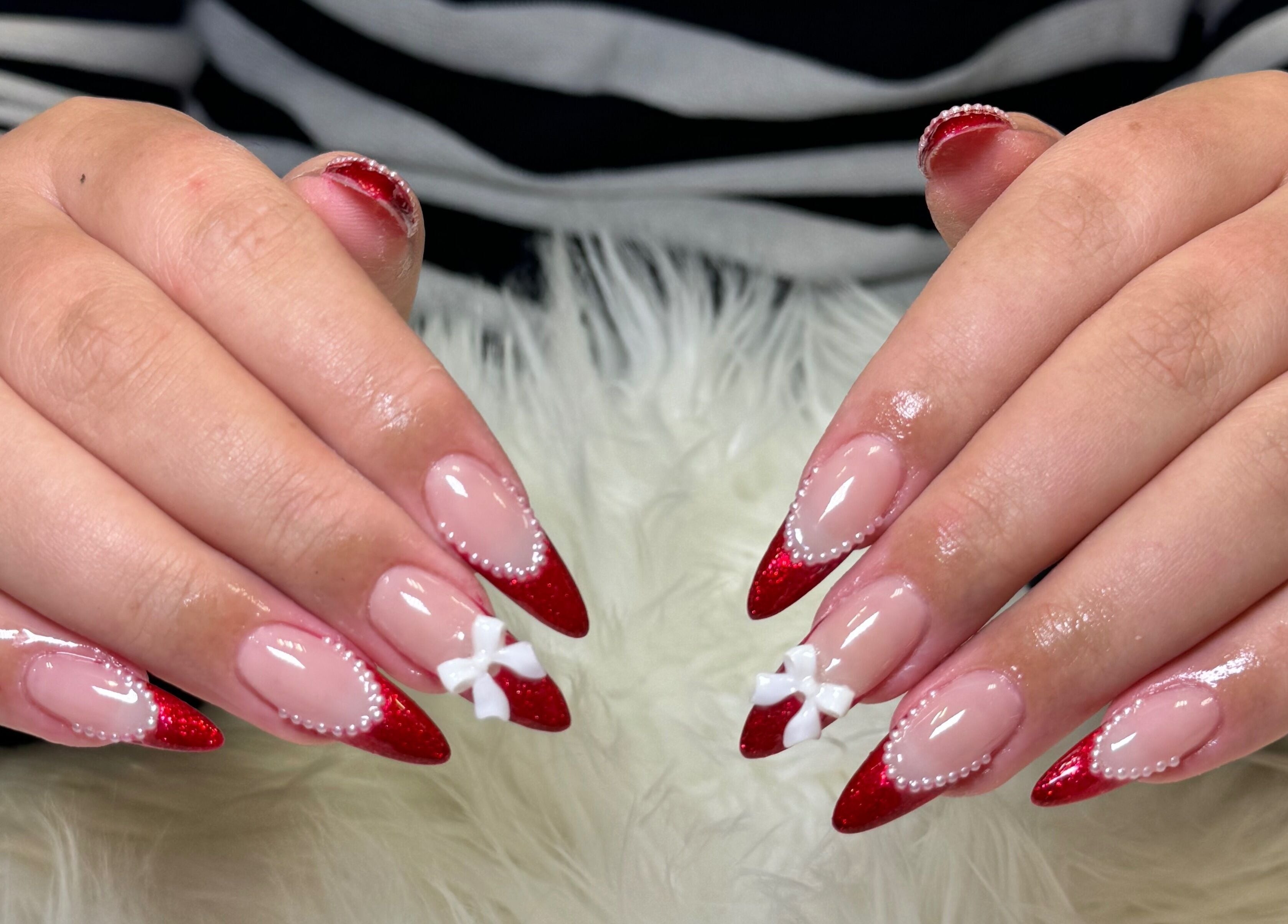 Red and white decorated nails at Beauticure Nails, Toronto, Ontario, CA.
