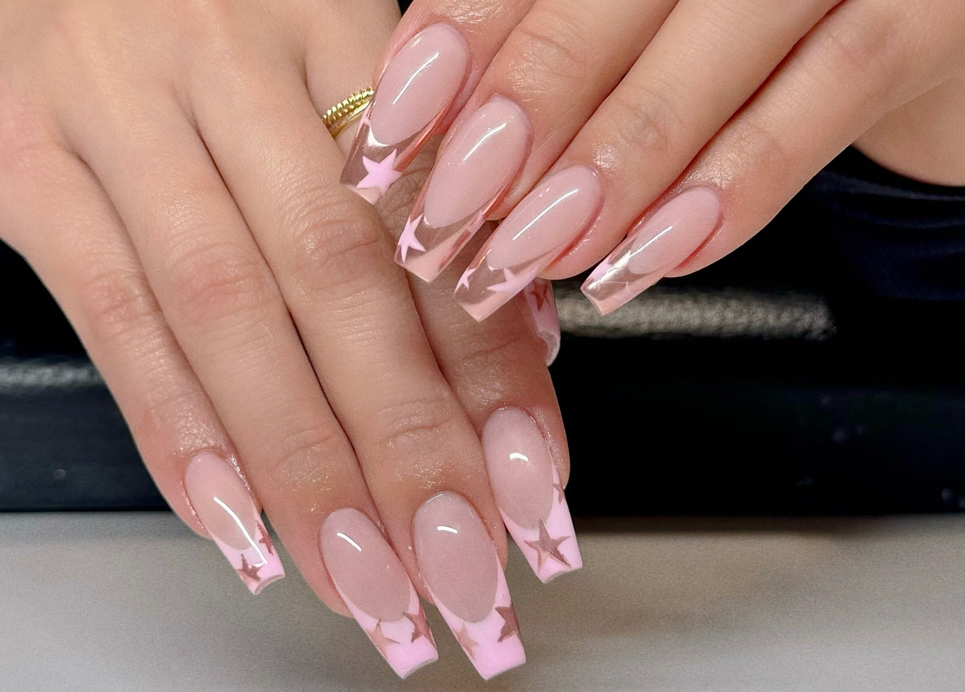 Gorgeous pink star-themed nails at Beauticure Nails in Toronto, Ontario, CA; elegant nail art.