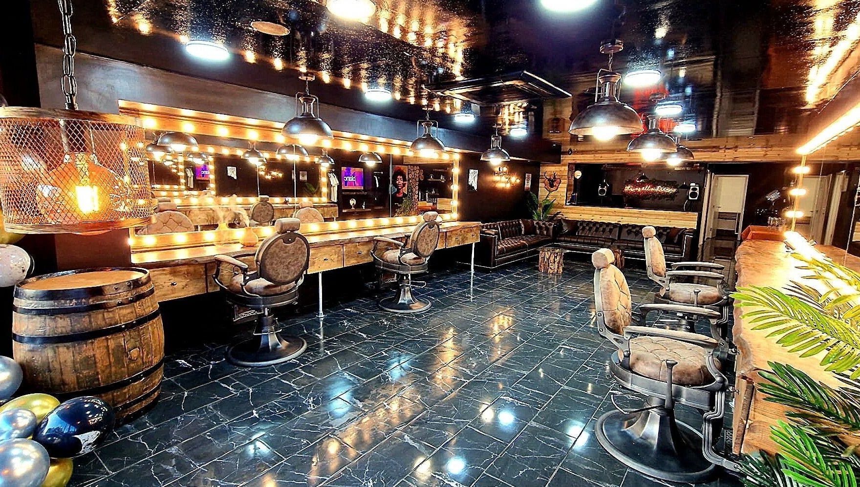 Elegant interior of Fade Masters Barbers & Tanning Salon Hale, Hale Barns, England, featuring stylish chairs and mirrors.