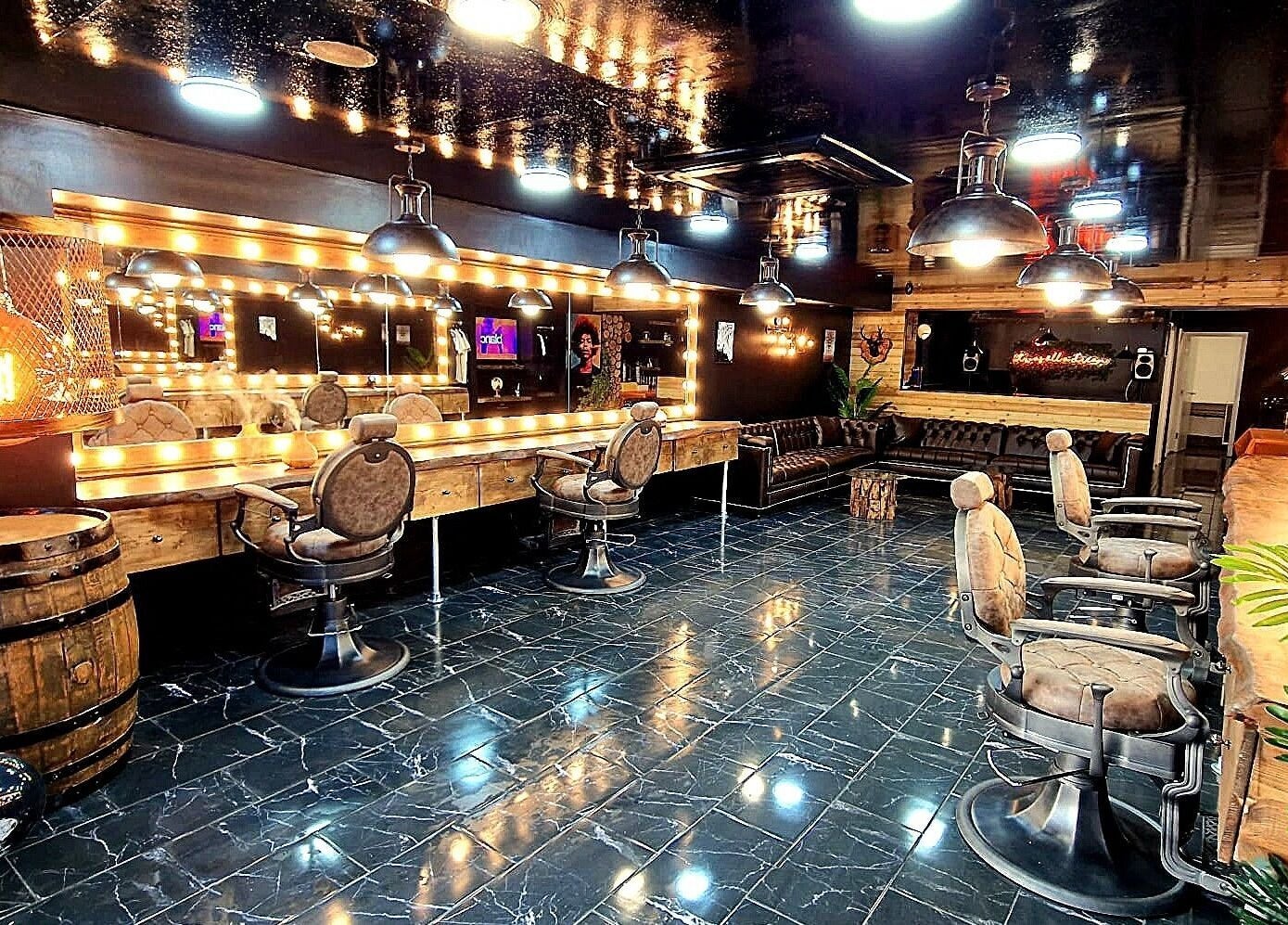 Elegant interior of Fade Masters Barbers & Tanning Salon Hale, Hale Barns, England, featuring stylish chairs and mirrors.
