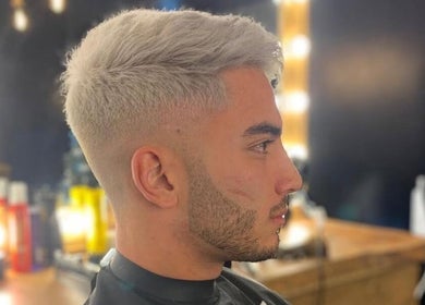 Stylish haircut at Fade Masters Barbers & Tanning Salon Hale in Hale Barns, England, GB with well-lit mirrors.