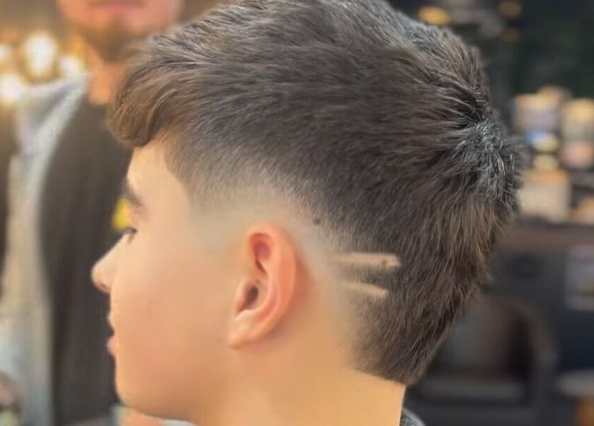 Detailed side view of a fresh fade haircut at Fade Masters Barbers & Tanning Salon Hale, Hale Barns, England, GB.