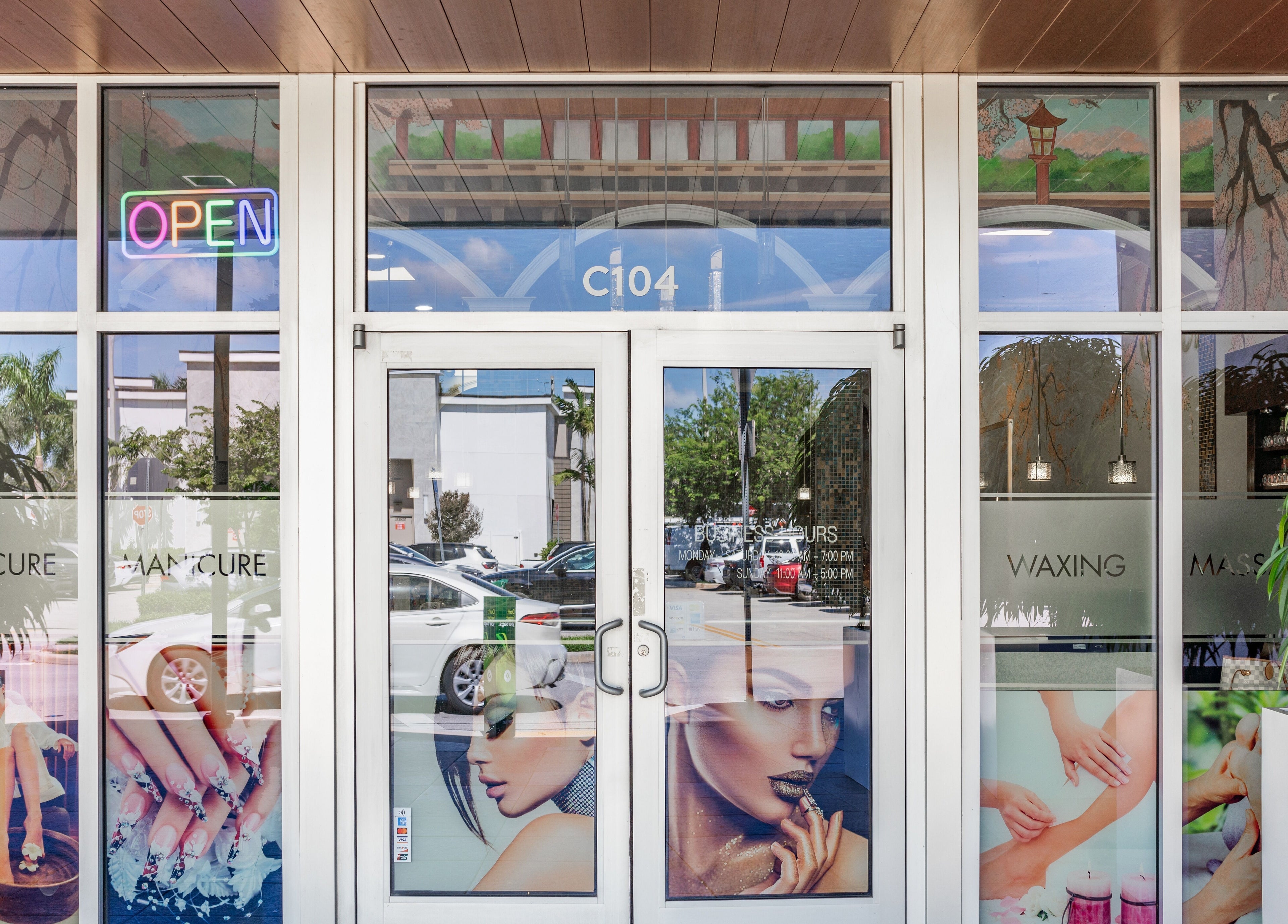 Front entrance of Angelic Nails Spa in Pembroke Pines, Florida, US, featuring vibrant nail art displays.
