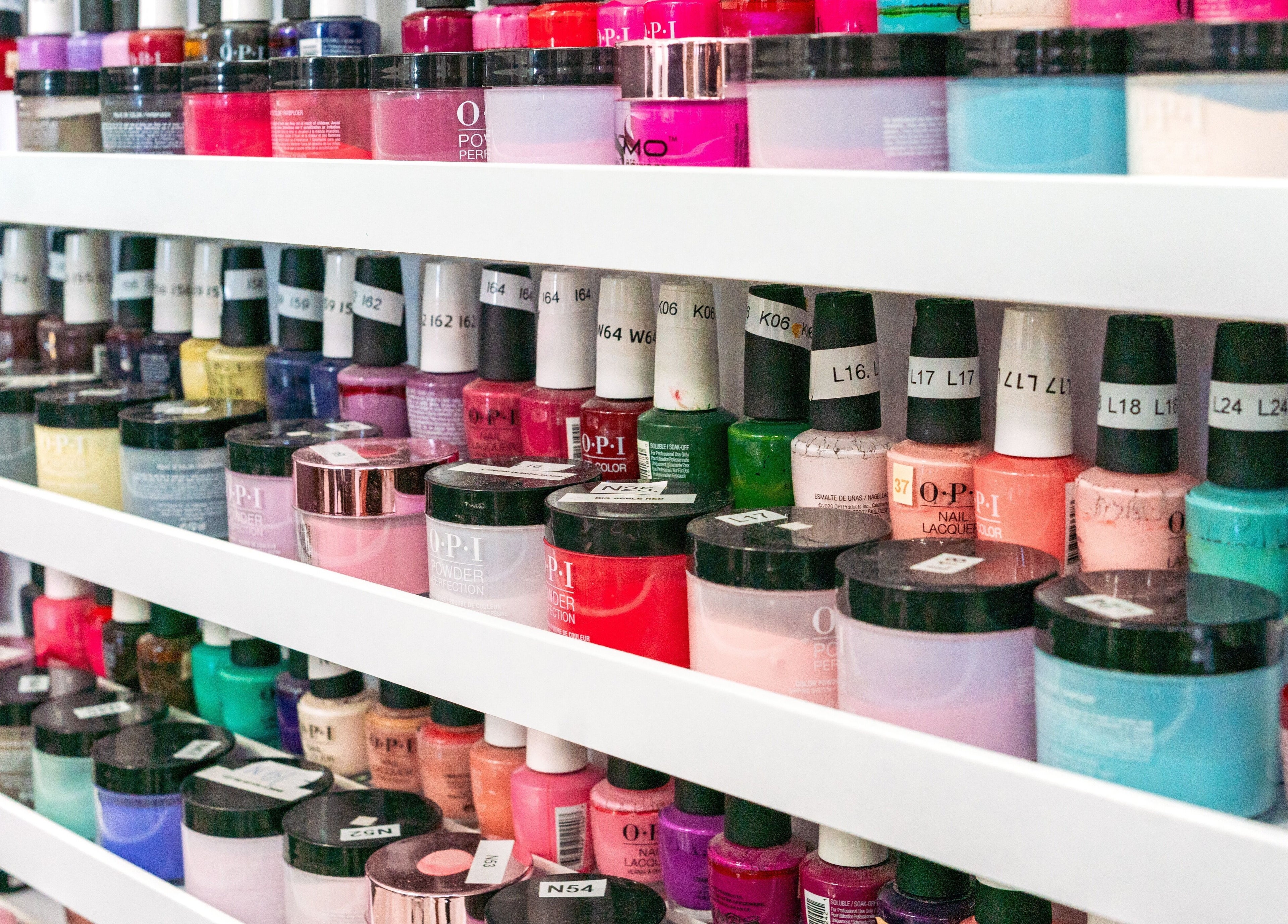 Diverse nail polish jars at Angelic Nails Spa, Pembroke Pines, Florida, US showcasing vibrant colors.