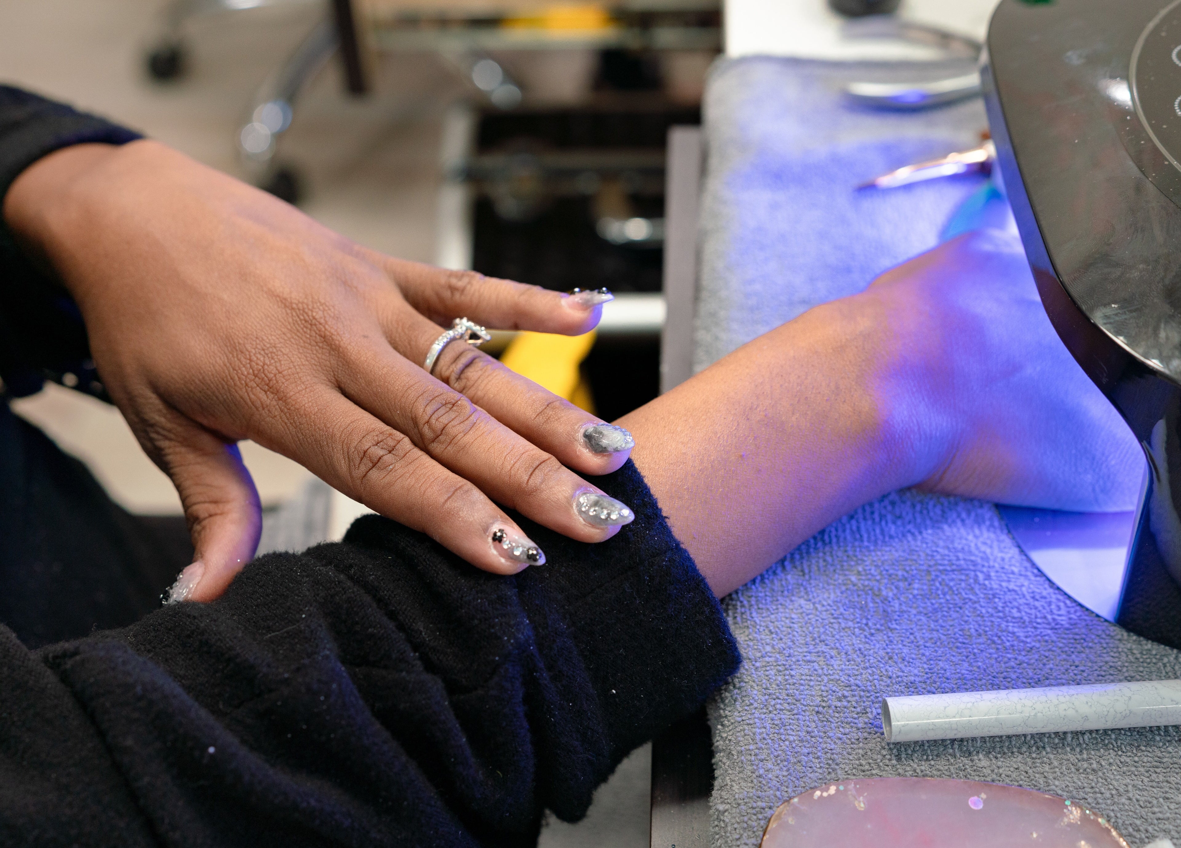 A client receiving beautiful nail art under a UV lamp at Angelic Nails Spa, Pembroke Pines, Florida, US.