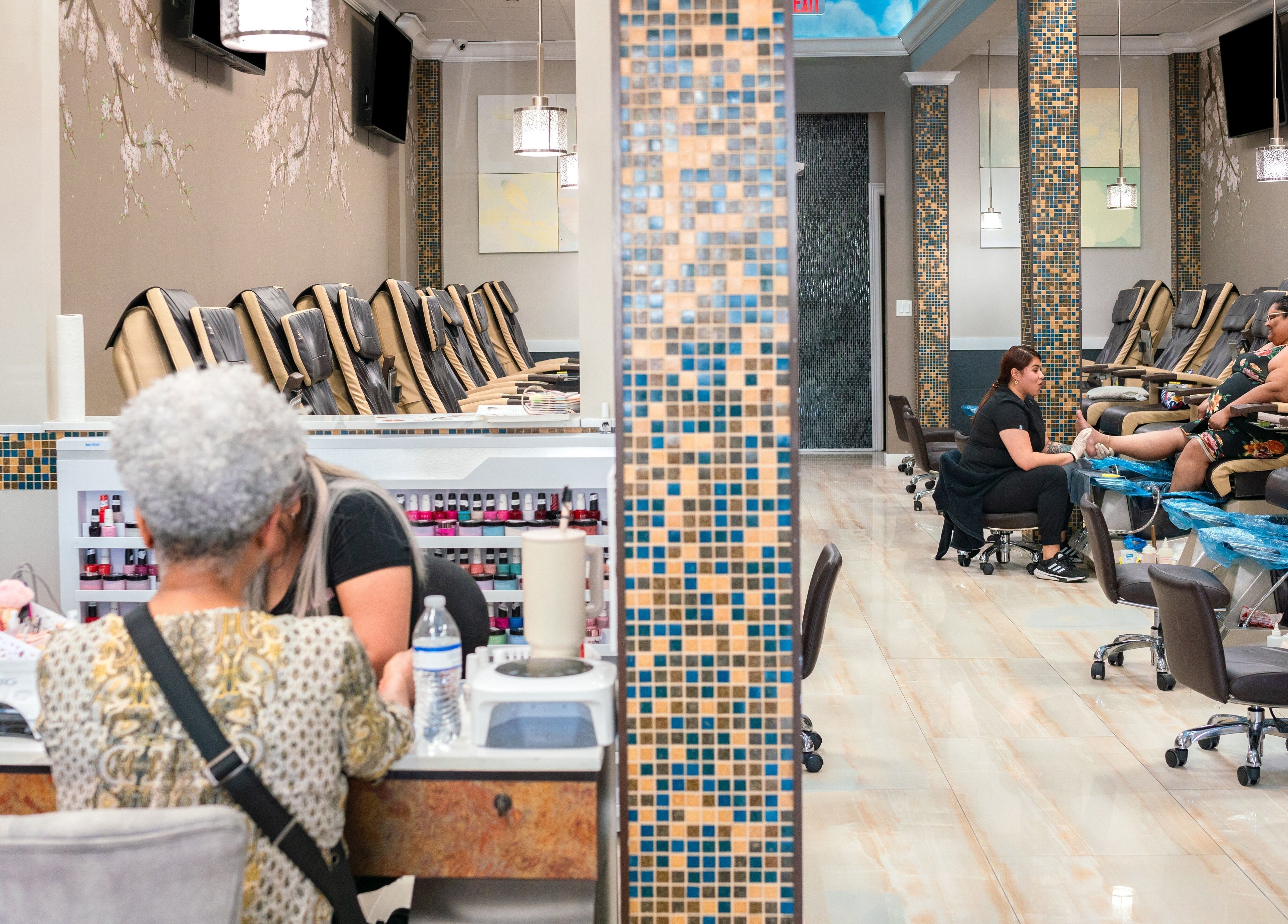 Inside Angelic Nails Spa in Pembroke Pines, Florida, US, showcasing pedicure chairs and nail polish displays.
