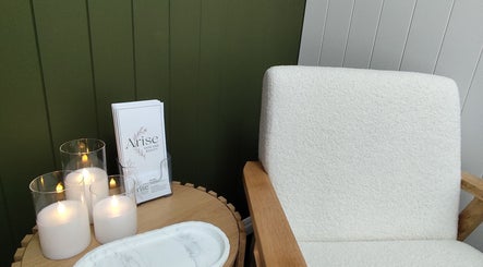Cozy corner at Arise Skin and Beauty with candles and brochures in Palmerston North, Manawatū-whanganui Region, NZ.
