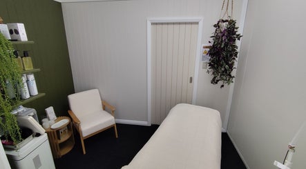 Therapy room at Arise Skin and Beauty, Palmerston North, NZ, featuring a treatment bed and calming decor.