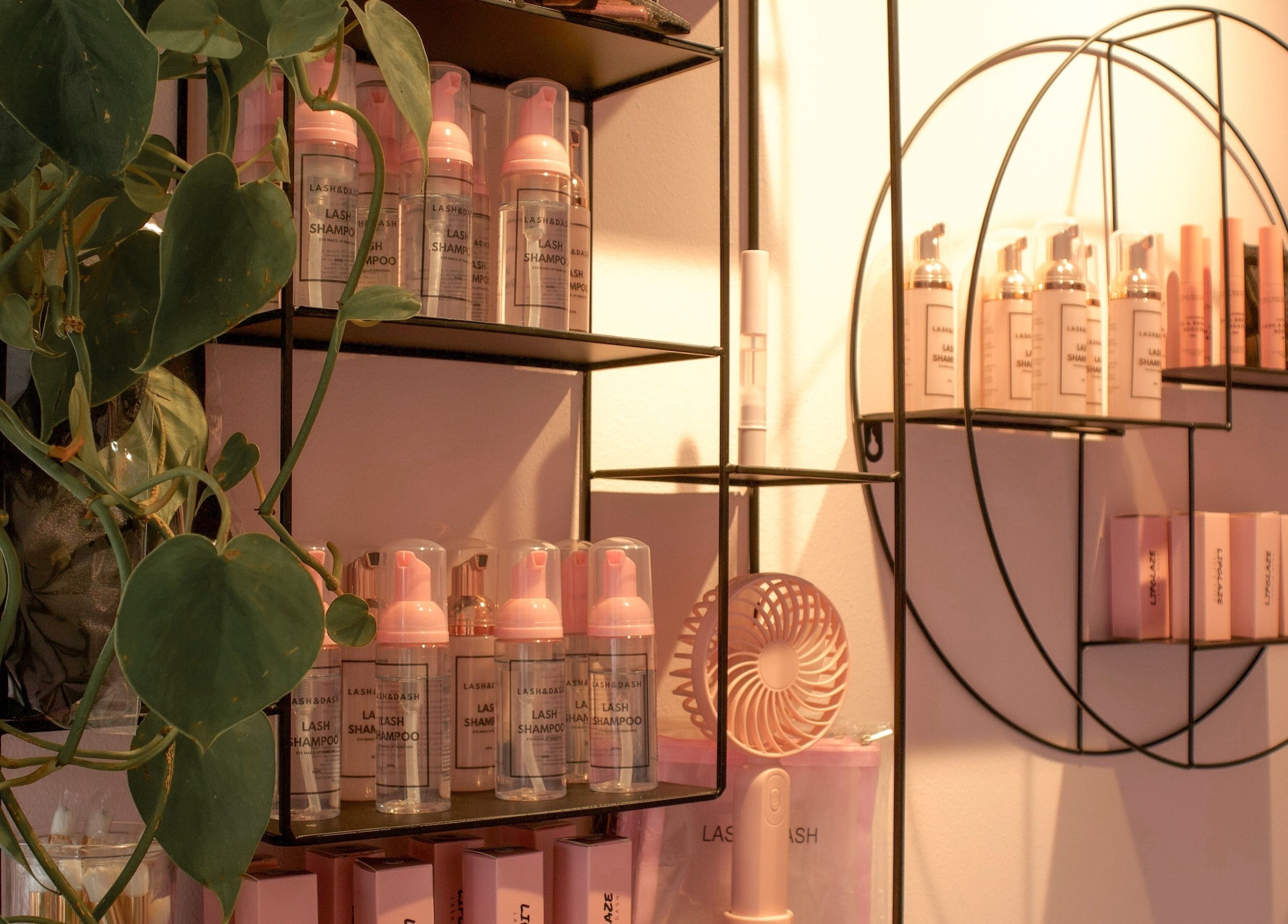 Chic beauty product display at Lash and Dash, Sandton, Gauteng, ZA featuring elegant shelving and vibrant plants.
