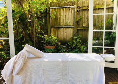 Outdoor massage setup at The Sanctuary, Kingscliff, New South Wales, AU surrounded by lush greenery.
