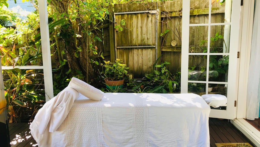 Tranquil outdoor massage setup at The Sanctuary, Kingscliff, New South Wales, AU surrounded by lush greenery.