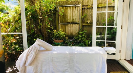 Tranquil outdoor massage setup at The Sanctuary, Kingscliff, New South Wales, AU surrounded by lush greenery.