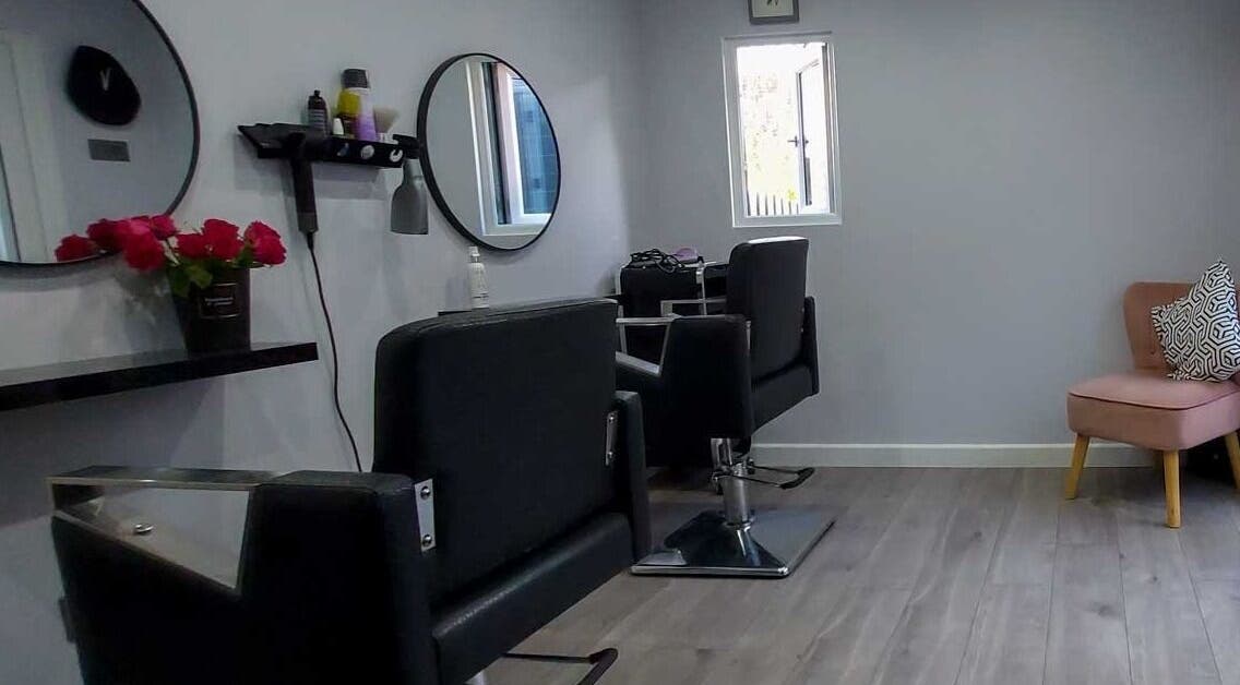 Stylish salon setup at Alchemy - Magical Hair Creation in Eastbourne, England, GB with chairs and mirrors.