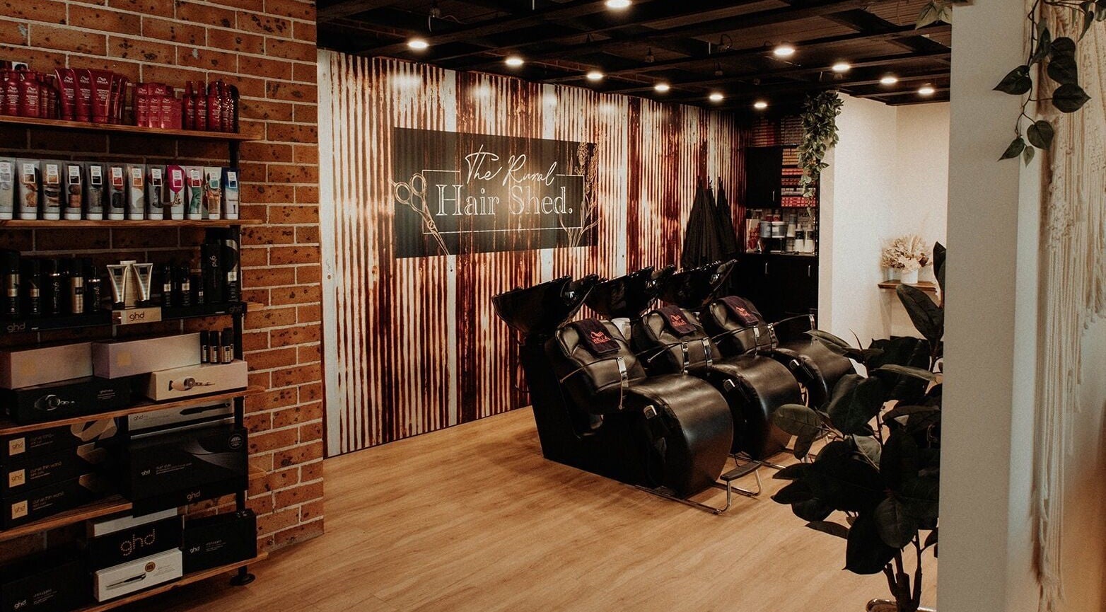 Inside The Rural Hair Shed Pty Ltd in Wilberforce, New South Wales, AU, showcasing styling products and wash stations.
