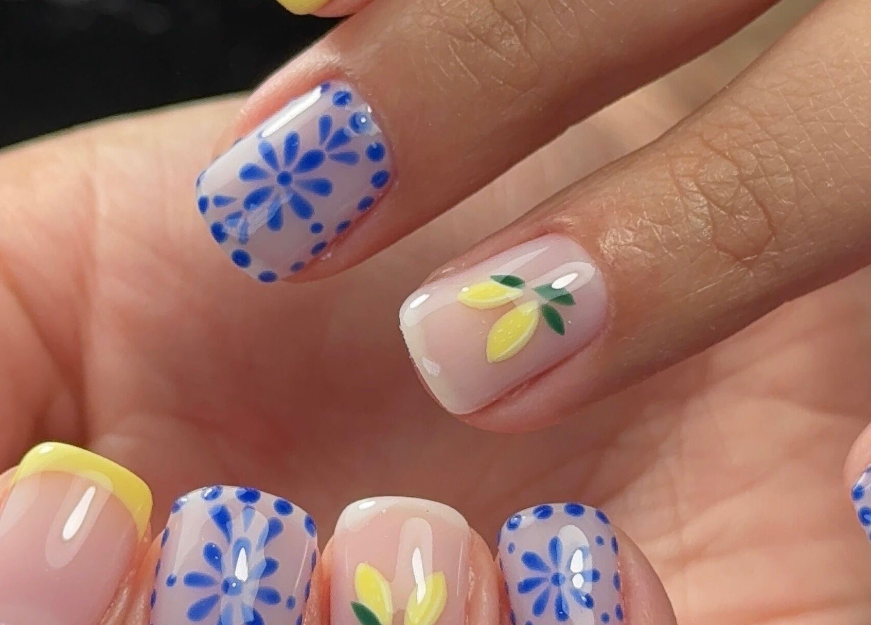 Colorful floral nails at Funkd Up Nails, Montréal, Québec, CA, showcasing intricate blue and yellow designs.