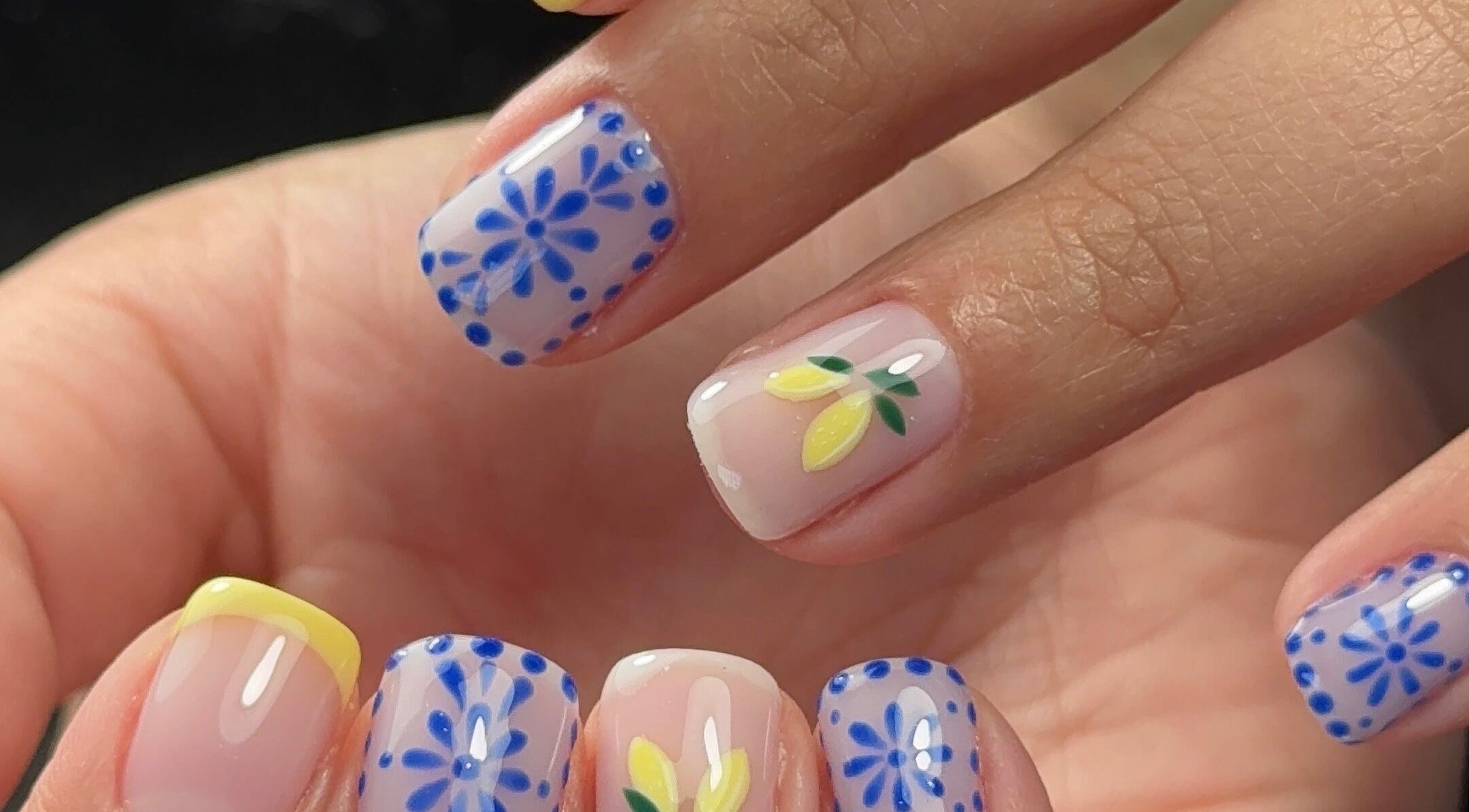 Colorful floral nails at Funkd Up Nails, Montréal, Québec, CA, showcasing intricate blue and yellow designs.