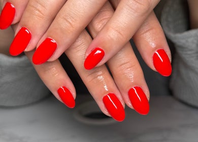 Vibrant red manicure at Nails by Natasha, Dorval, Quebec, CA, showcasing meticulous nail art.