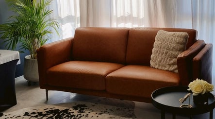 Warm leather couch and elegant decor at Beauty Therapeutics, Oran Park, New South Wales, AU.
