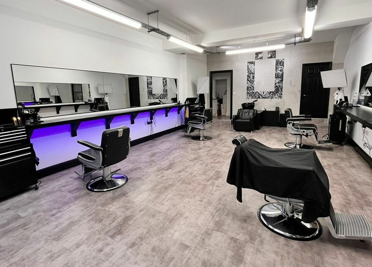 Ünknown Barbers in Guernsey, Saint Peter Port offers a modern, stylish barber interior with sleek chairs and decor.