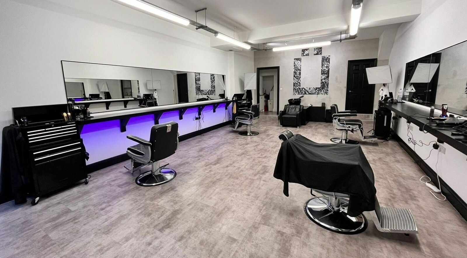 Ünknown Barbers in Guernsey, Saint Peter Port offers a modern, stylish barber interior with sleek chairs and decor.
