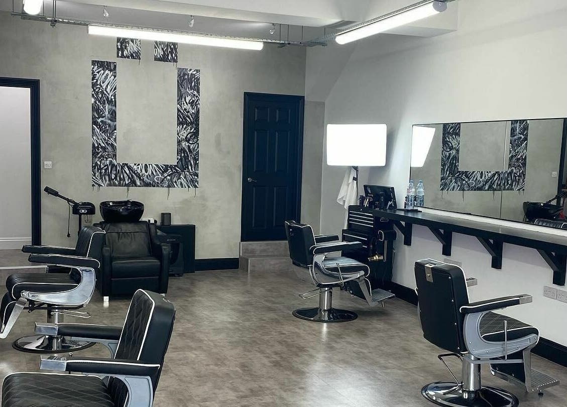 Ünknown Barbers in Guernsey, Saint Peter Port features a modern, stylish interior with sleek barber chairs.