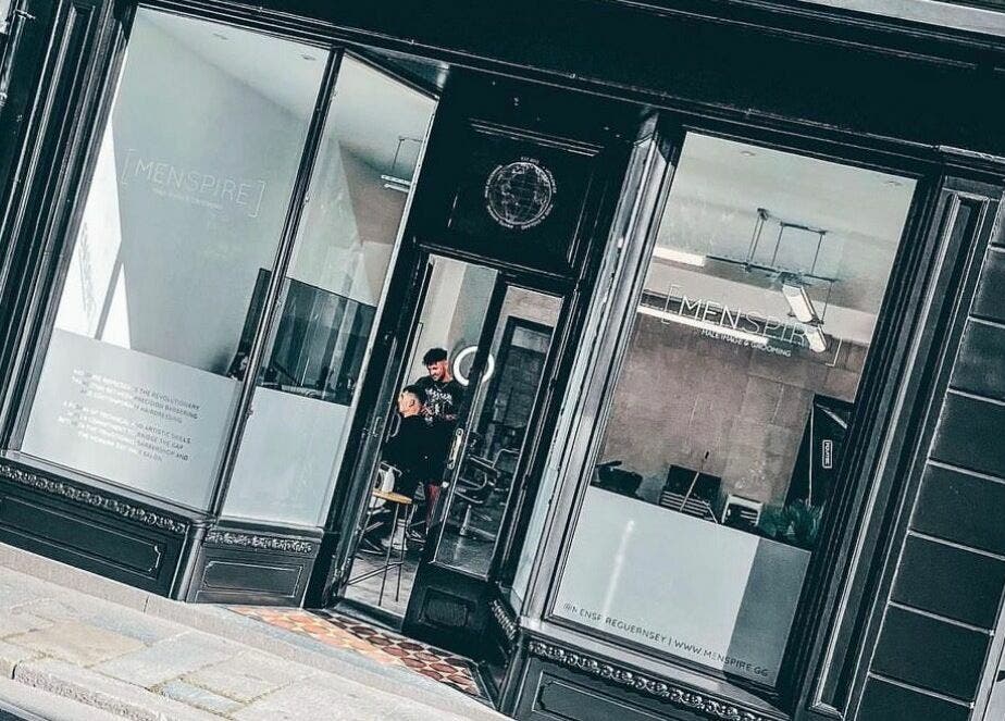 Stylish exterior of Ünknown Barbers in Guernsey, Saint Peter Port, GG, showcasing modern design.