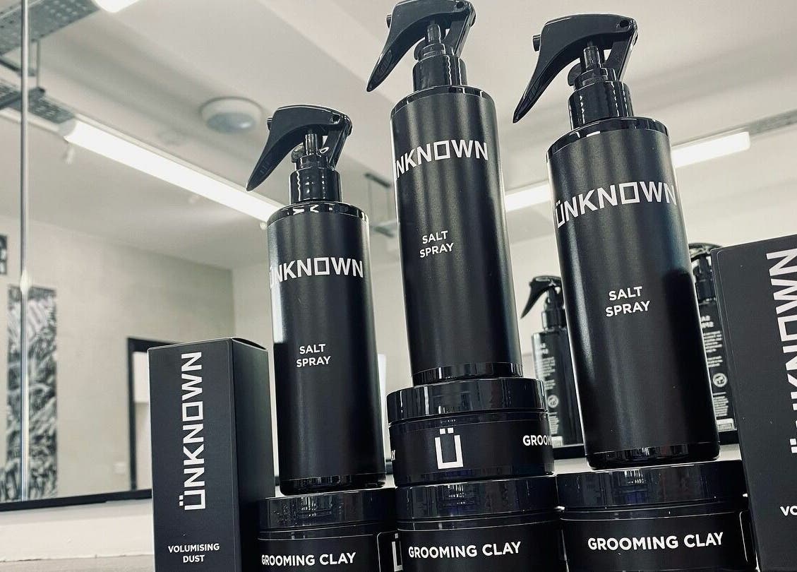 Ünknown Barbers styling products in Guernsey, Saint Peter Port, GG barber shop display.