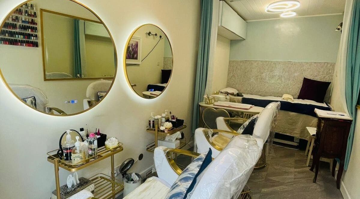 Chic interior of Tan's Brows and Beauty, Ranelagh, Dublin, showcasing plush chairs and stylish mirrors.