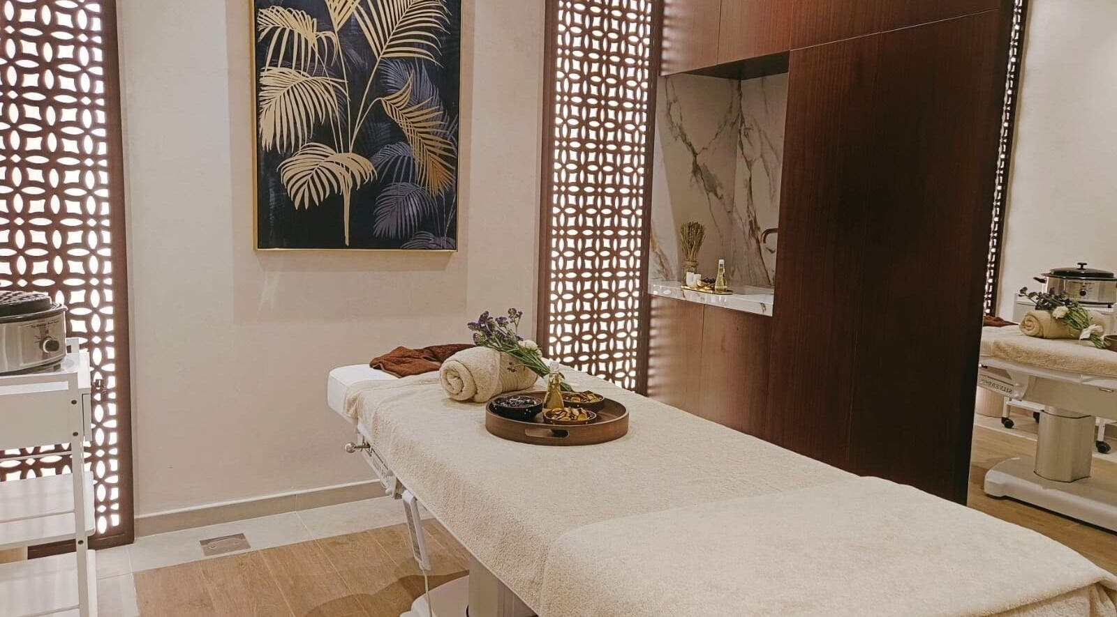 Peaceful massage room at Healing Zone Spa, Sharjah, AE, featuring a cozy table with elegant decor.