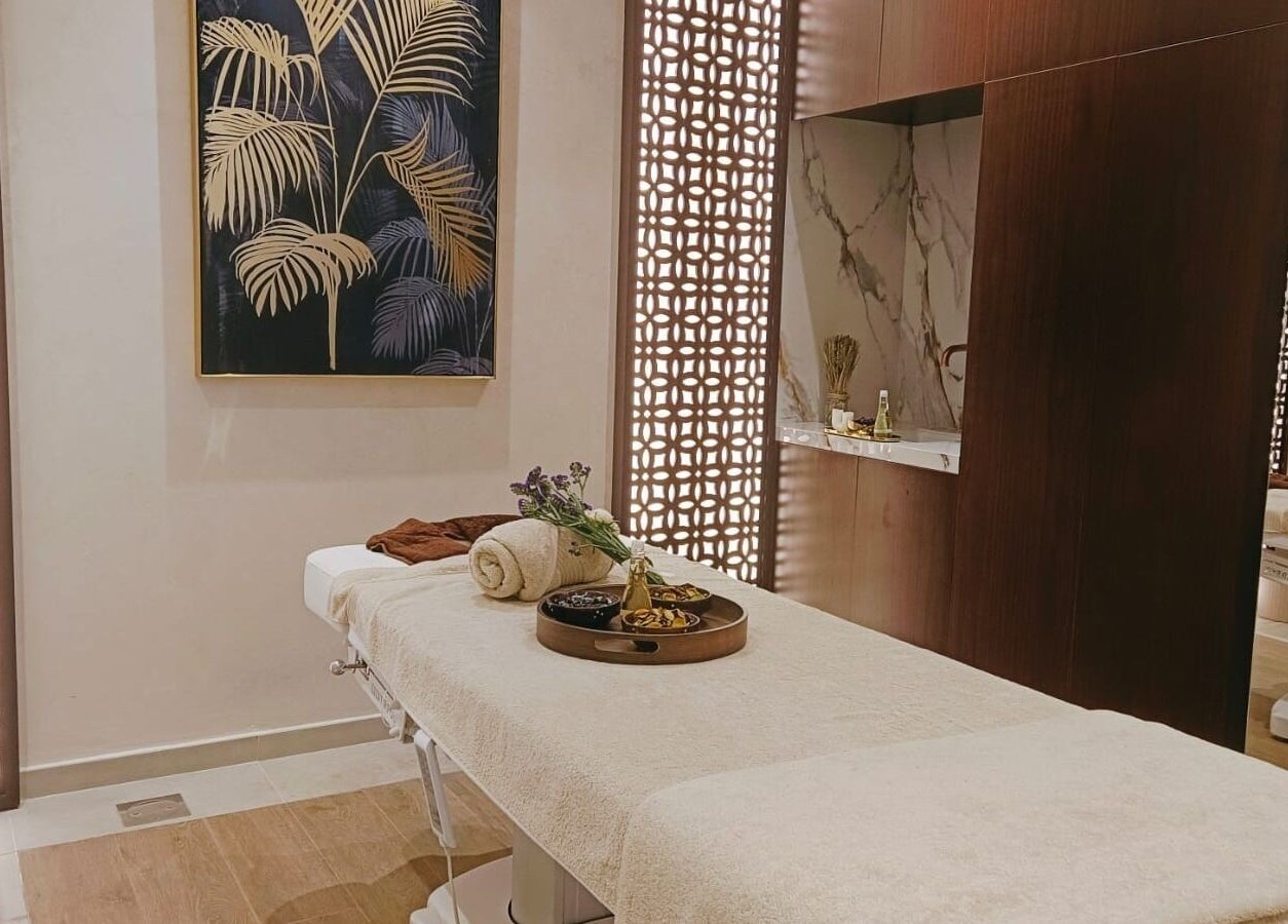 Serene massage room at Healing Zone Spa, Sharjah, AE, featuring a plush treatment table and calming decor.