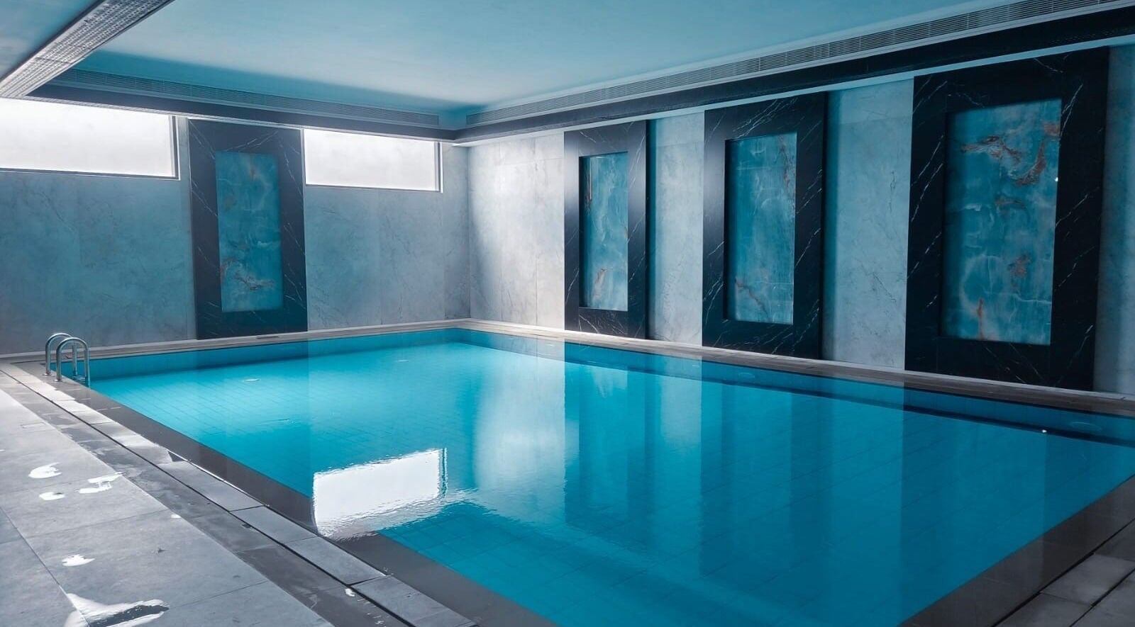 Tranquil indoor pool at Healing Zone Spa in Sharjah, AE, offering a relaxing wellness retreat.