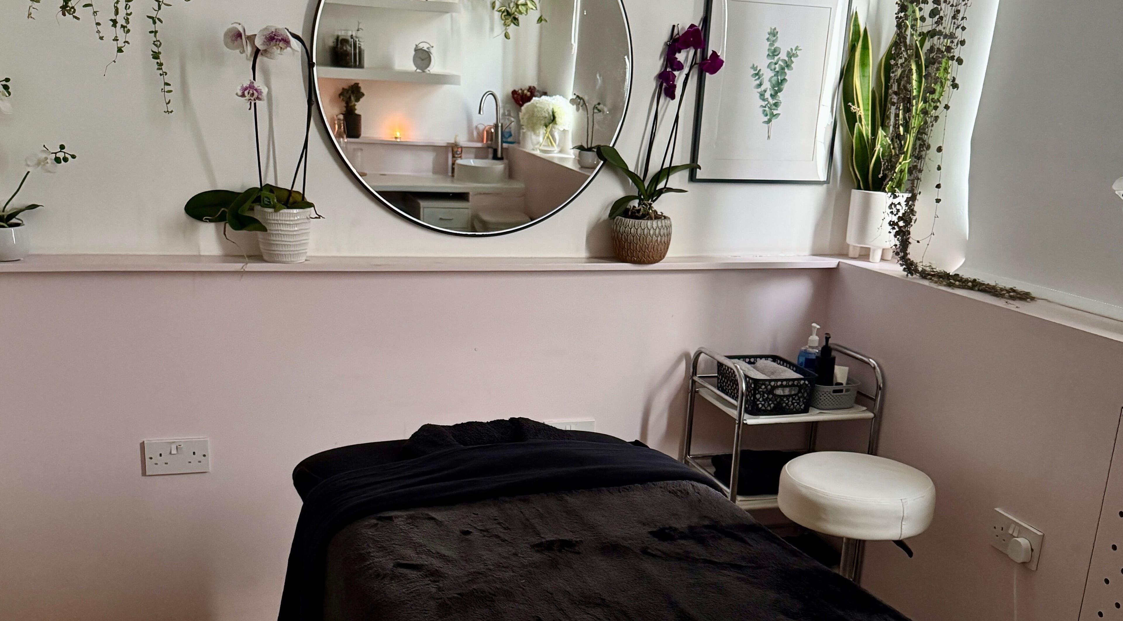 DreamyTherapy's calming treatment room in London, England, GB, featuring a plush bed and tranquil decor.