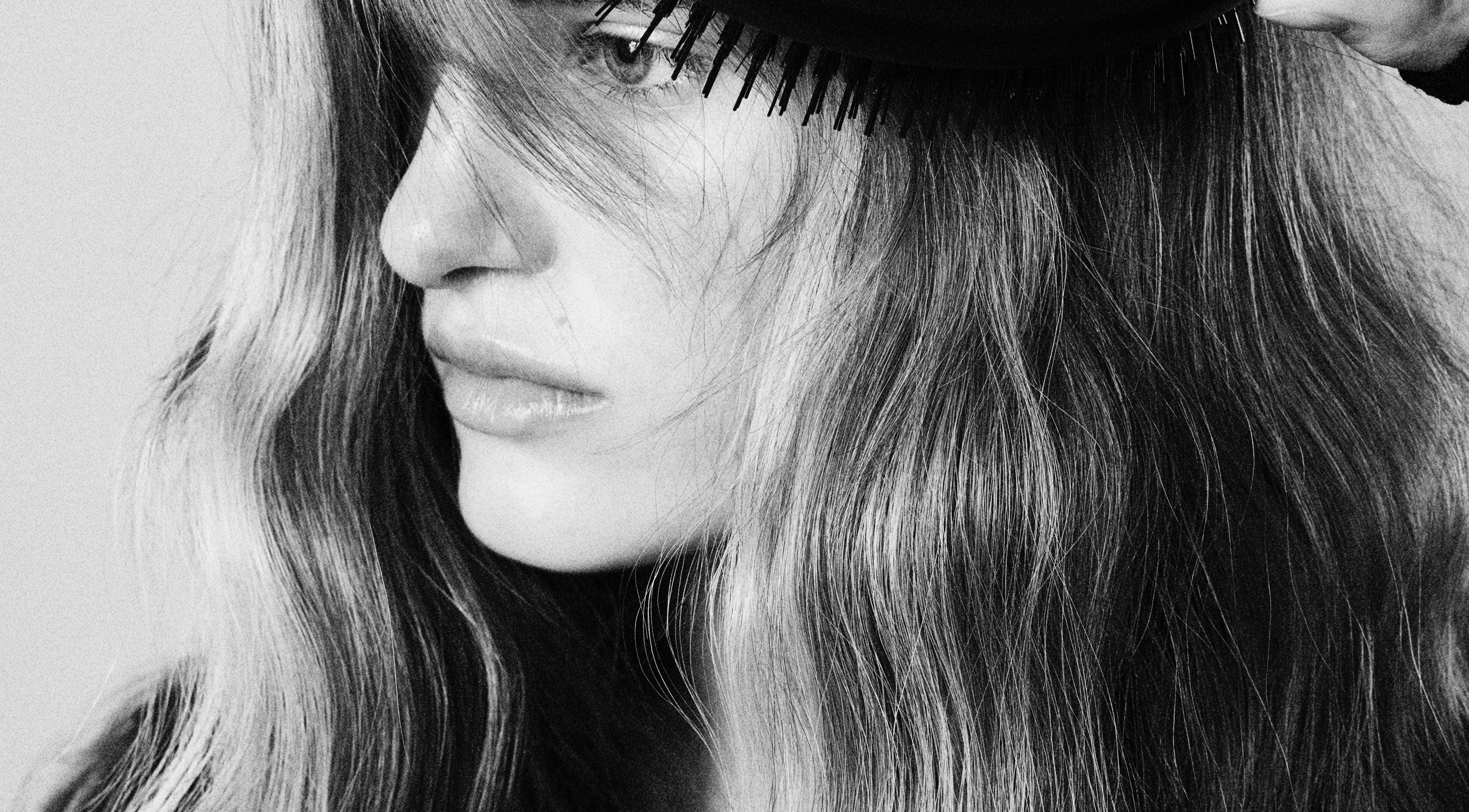 Close-up of graceful hair being brushed at Popellas Hair & Extensions, Bournemouth, England, GB.