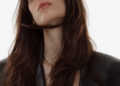Stylish woman with glossy hair wearing a leather jacket at Popellas Hair & Extensions, Bournemouth, England, GB.