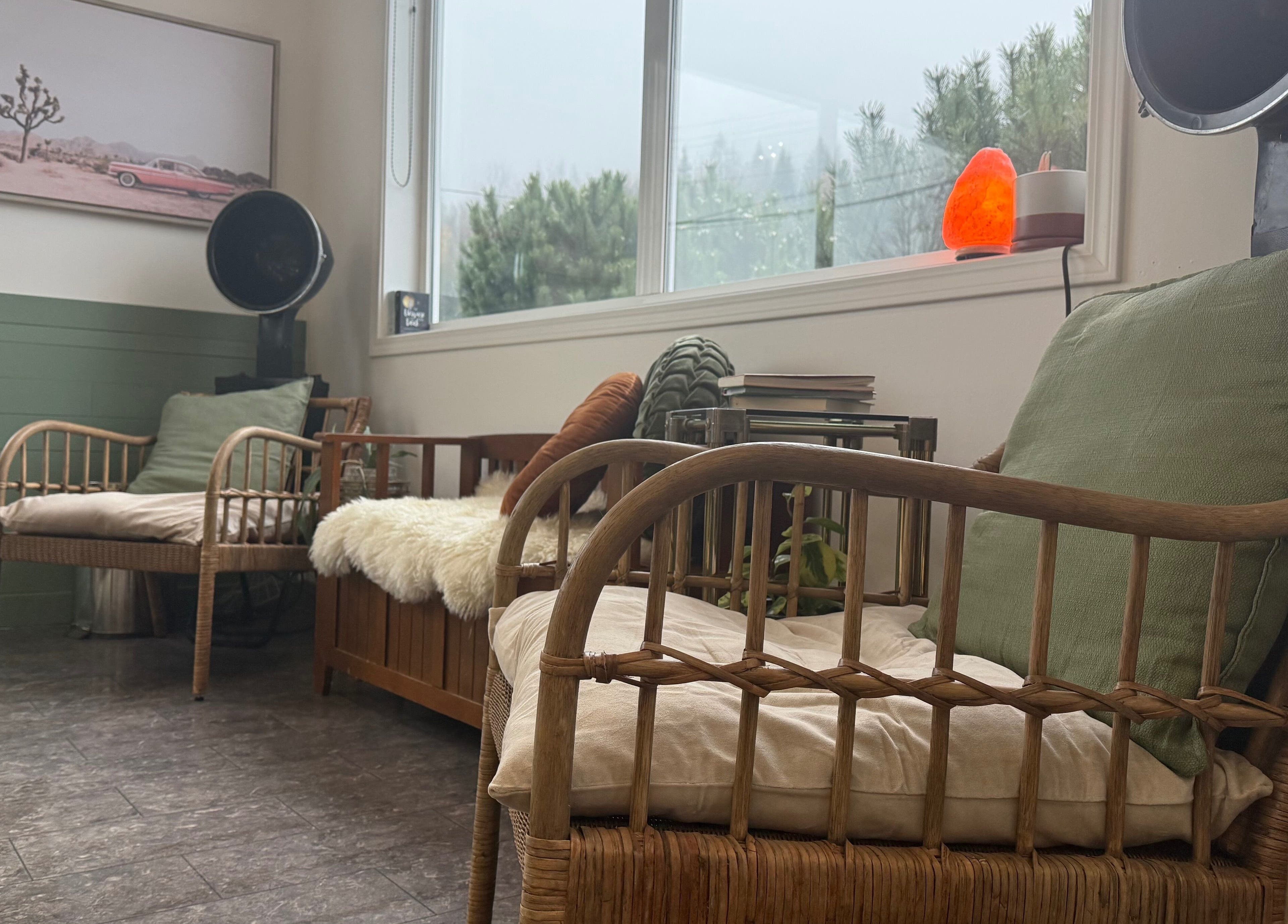 Relaxing lounge area with wicker chairs at The Collective Beauty Company, Revelstoke, British Columbia, CA.