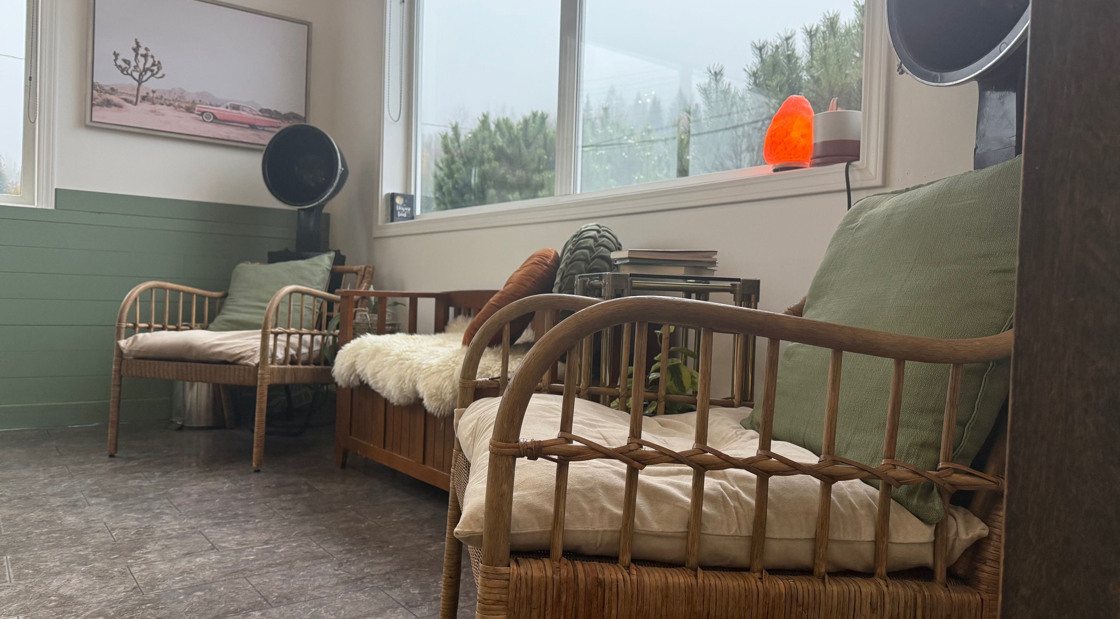 Relaxing lounge area with wicker chairs at The Collective Beauty Company, Revelstoke, British Columbia, CA.