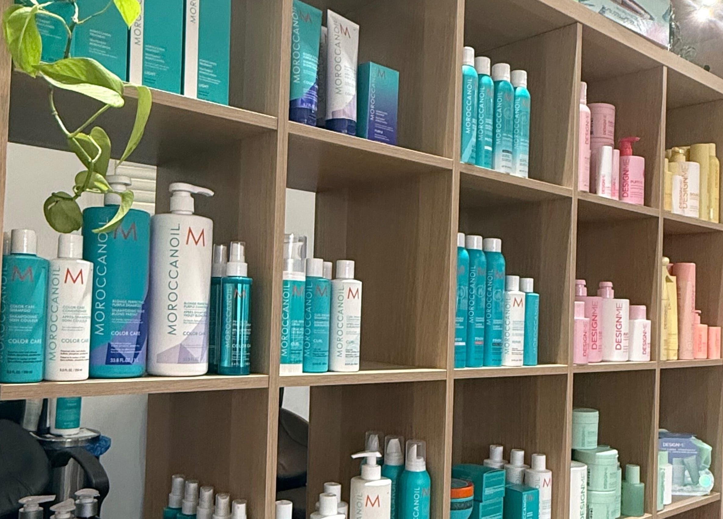 Haircare products displayed on wooden shelves at The Collective Beauty Company in Revelstoke, British Columbia, CA.