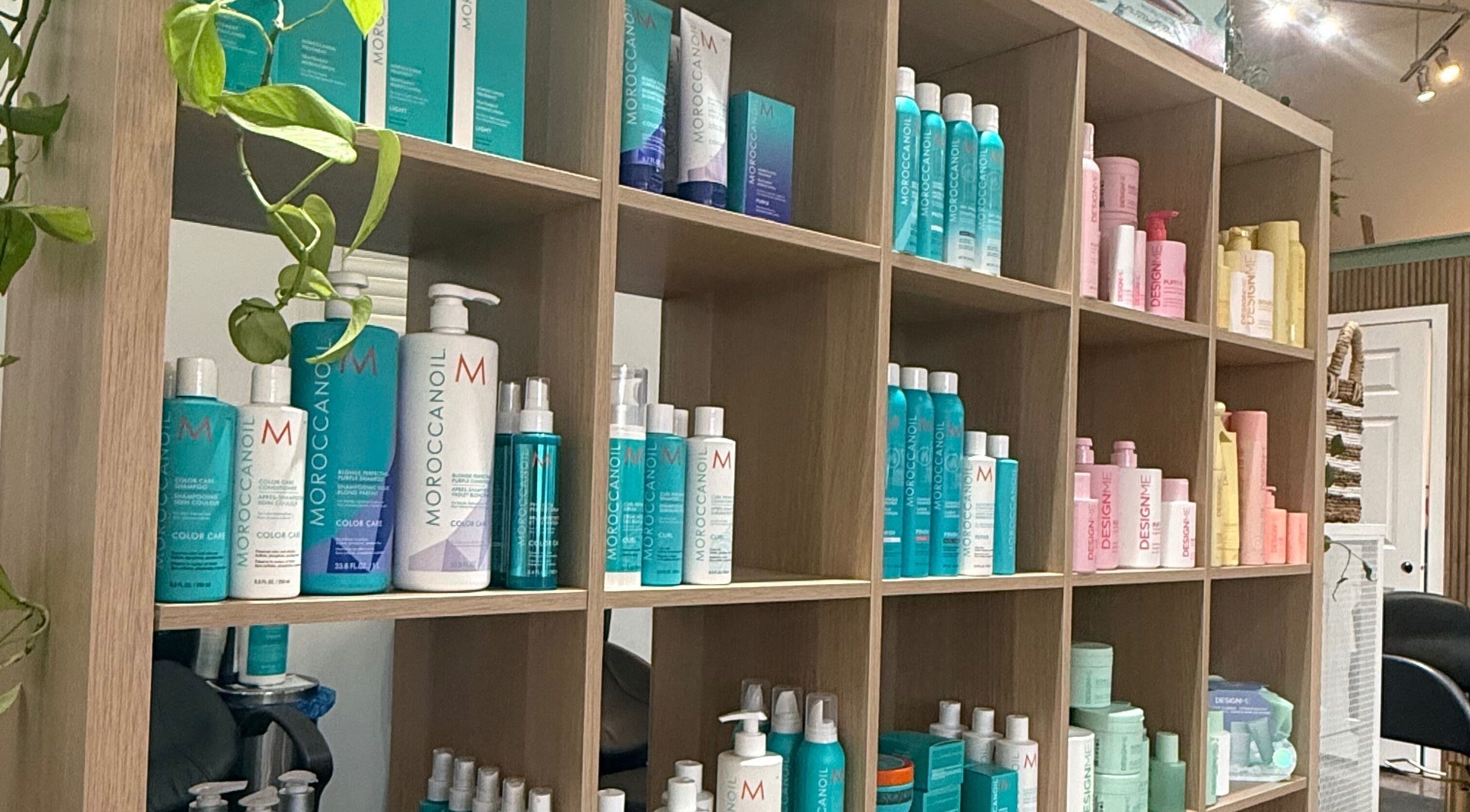 Haircare products displayed on wooden shelves at The Collective Beauty Company in Revelstoke, British Columbia, CA.