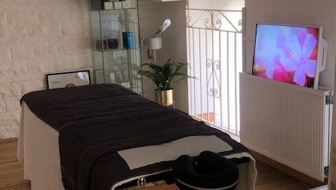 Relaxing treatment room at Zen Botanica, Barry, Wales, GB with massage table and soothing decor.