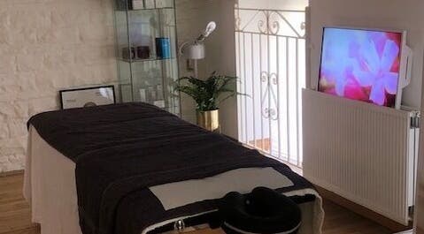 Relaxing treatment room at Zen Botanica, Barry, Wales, GB with massage table and soothing decor.