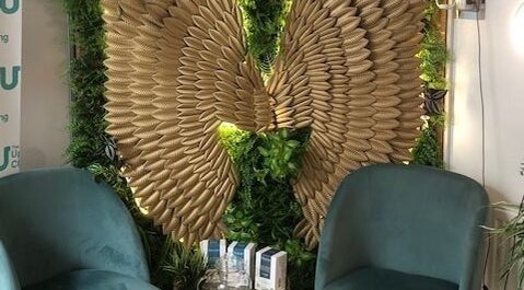 Elegant seating with golden wing decor at Zen Botanica, Barry, Wales, GB.