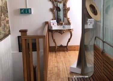 Charming interior decor at Zen Botanica, Barry, Wales, GB, showcasing vintage wooden accents and an ornate mirror.
