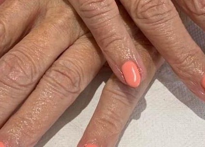 Manicure with coral polish at Zen Botanica, Barry, Wales, GB.