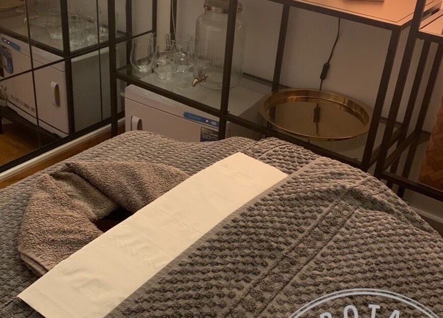 Relaxing massage room at Zen Botanica, Barry, Wales, GB, featuring plush towels and serene atmosphere.