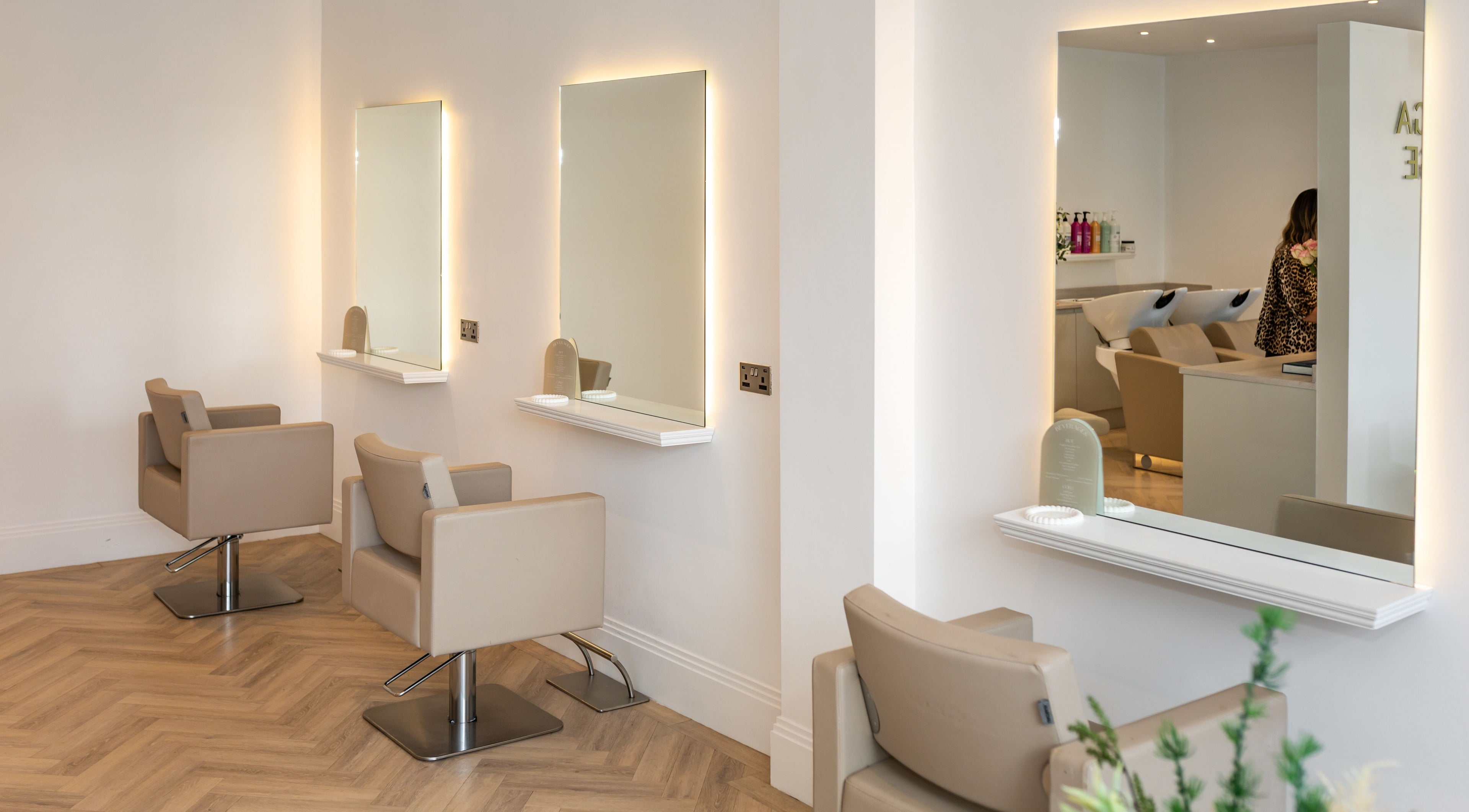 Chic interior of Bottega Lounge in Banstead, England. Modern salon chairs and mirrors create a stylish ambiance.