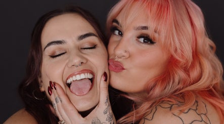 Two people smiling at Bold Beauty Esthetics, Oklahoma City, Oklahoma, US, showcasing vibrant hairstyles and makeup.