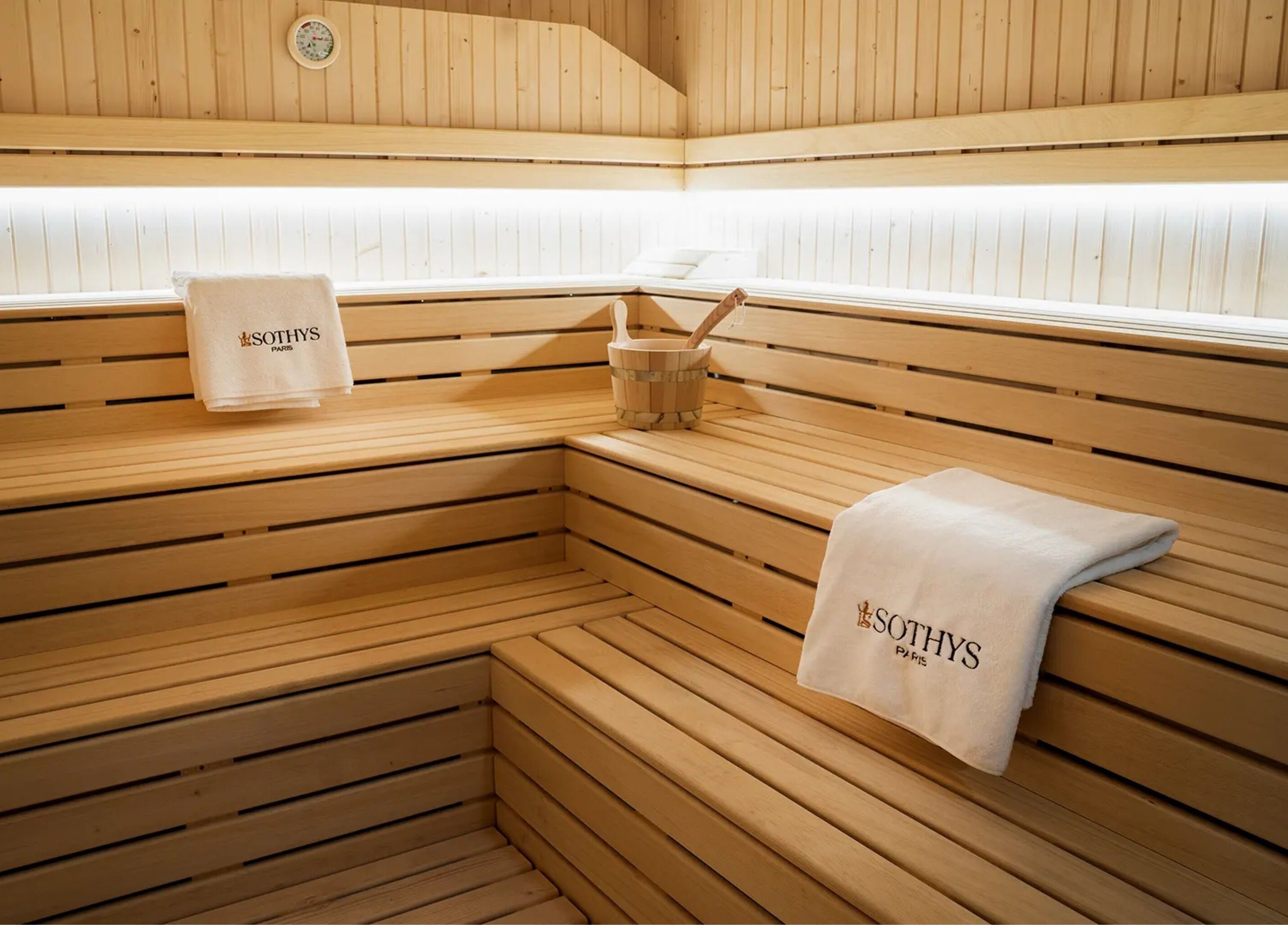 Luxurious sauna room at E1 Spa and Wellness, Gibraltar, GI featuring wooden interiors and soft lighting.