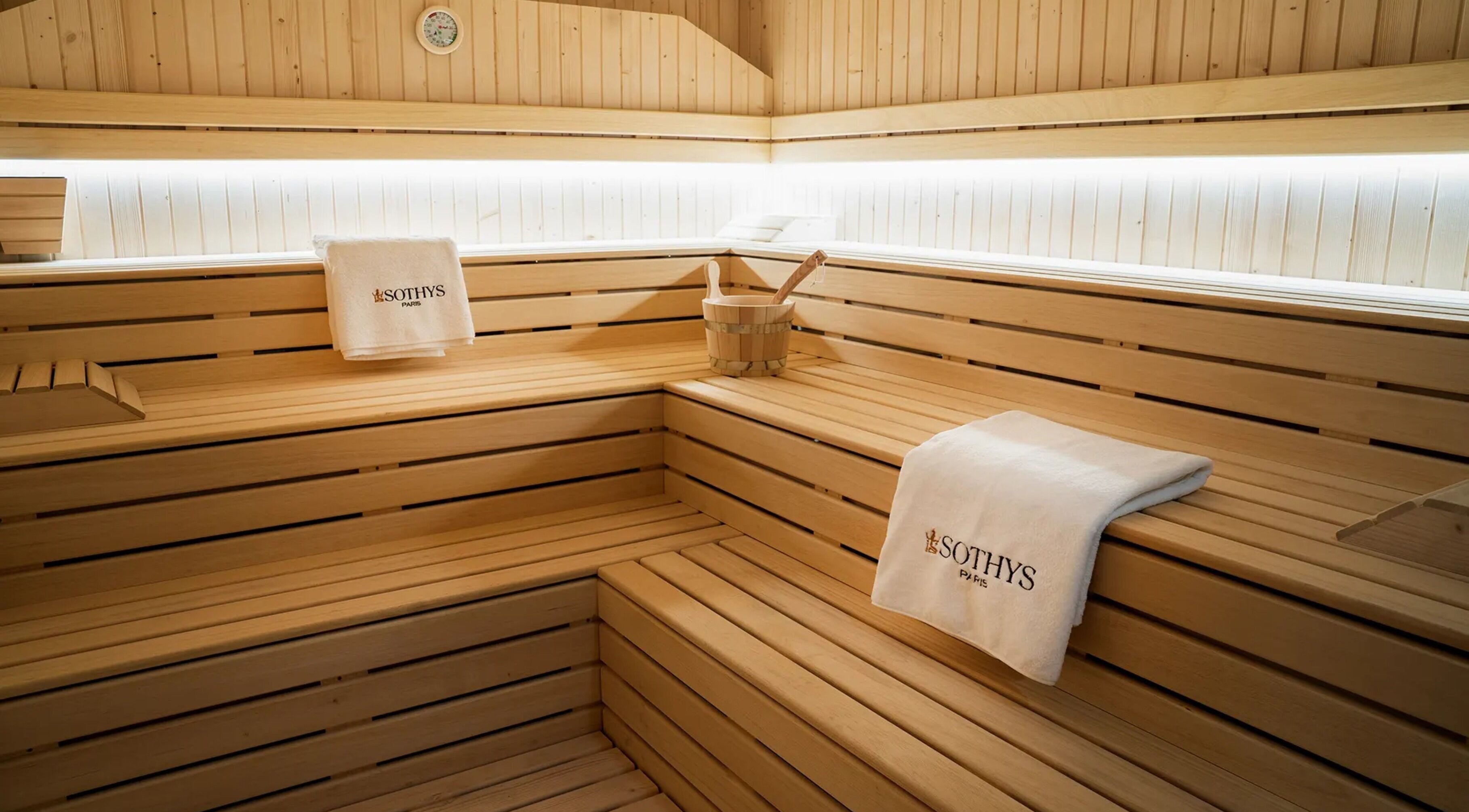 Luxurious sauna room at E1 Spa and Wellness, Gibraltar, GI featuring wooden interiors and soft lighting.